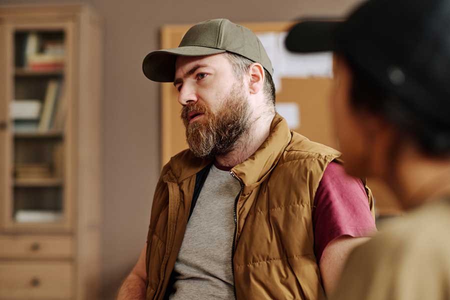 Man participating in a court-mandated substance abuse counseling session with a therapist.