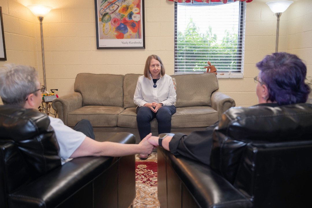 Lighthouse Counseling clinicians in a welcoming Fredericksburg office setting with LGBTQ couple