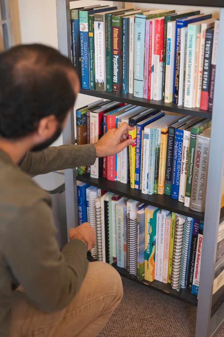 clinician choosing therapy book