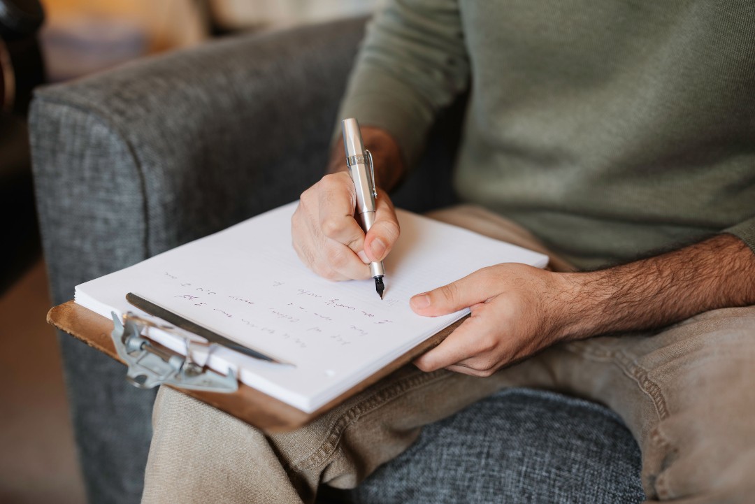 therapist with a clipboard writing notes